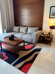 a living room with a couch and a coffee table at Treppan Hotel & Suites By Fakhruddin in Dubai