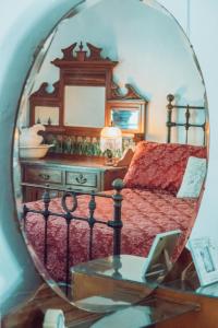 a bedroom with a bed and a mirror on a table at Dingup House in Manjimup