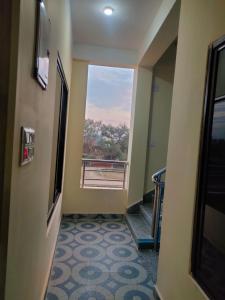 a hallway with a view of a room with a window at Kavre Guest House in Rummindei