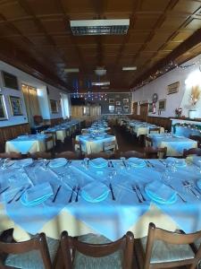 a large dining room with blue tables and chairs at Hotel Moderno in Aritzo