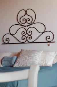 a bed with a metal frame on the wall at B&B The Wine Room - Az. Agr. Matunei in Cardona