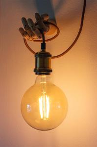 a large light bulb hanging from a ceiling at B&B The Wine Room - Az. Agr. Matunei in Cardona