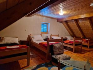 a attic room with two beds and a window at FoRest in Jasenak