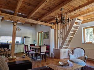 a living room with a staircase and a table at FoRest in Jasenak