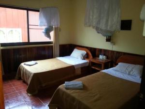 A bed or beds in a room at Pon's Riverside Guesthouse