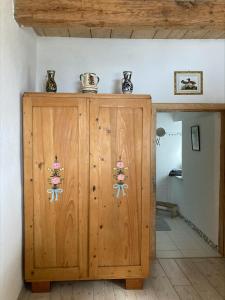 a wooden cabinet with two vases on top of it at CasaBleiberg - Garten Apartment - Naturpark Dobratsch in Bad Bleiberg