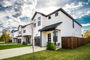 a white house with a black roof at Beautiful Contemporary 4BR near Downtown Dallas in Dallas