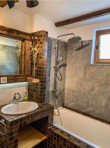 a bathroom with a sink and a shower and a tub at Heimelige Ferienwohnung mit Sicht in die Bergwelt in Bivio