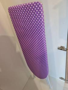 a purple chair sitting next to a wall at Lovely Kozi Square Studio Bedroom with Pool LV5C in Kuching +16 photos
