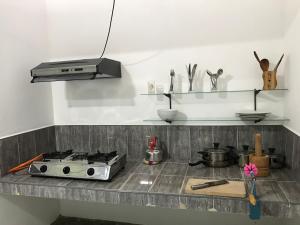 a kitchen with a stove and a counter top at aji fruit farm in Embilipitiya