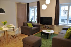 a living room with a couch and a table at Apartments City&style in Zagreb