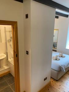 a bedroom with a bed and a tub and a bathroom at Dunes View, Cottage1, Dunnetbay accommodation in Castletown