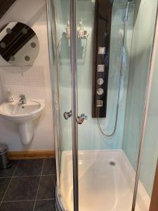 a bathroom with a shower and a sink at Dunes View, Cottage1, Dunnetbay accommodation in Castletown