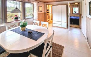 a dining room with a table and chairs at Awesome Home In rjng With House Sea View in Östra Viker