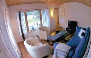 a living room with a couch and chairs and a table at Awesome Home In rjng With 3 Bedrooms And Wifi in Östra Viker