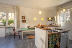 a kitchen with a table and a counter top at Casa Bartoli in San Vincenzo