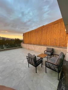 a patio with two chairs and a table on a balcony at Loft mit Terrasse und Blick auf den Goldenen Horn. in Istanbul