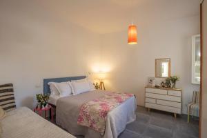 a bedroom with a bed and a dresser and a mirror at Casa Bartoli in San Vincenzo