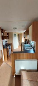 a kitchen with a sink and a counter top at Springs 46 by Vilija Southview Leisure Park Skegness in Skegness +41 photos