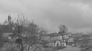 a black and white photo of a village with a church at Locanda San Martino in Massac