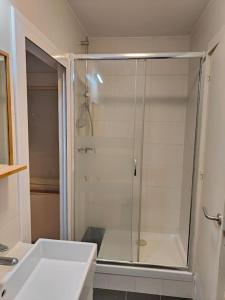 a bathroom with a shower with a glass door at Cute apartment Sant Adria beach in Sant Adria de Besos