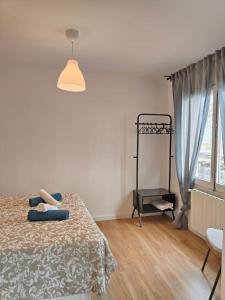 a white room with a bed and a window at Cute apartment Sant Adria beach in Sant Adria de Besos