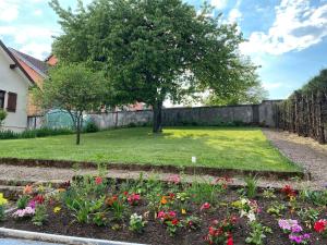 a garden with flowers and a tree at Gîte du cerisier in Raddon-et-Chapendu