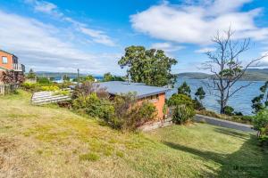 an image of a house with a view of the water at The Beach House- private jacuzzi and wood fire! in Dover