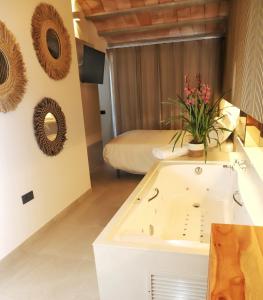 a bathroom with a sink and a bed at Les Cases del Mar in Les Cases d'Alcanar