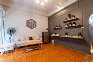 a living room with a couch and a table at J Cube Betong - Private House in Betong