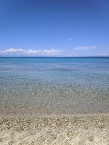 a beach with a large body of water at Villa Beta - 5min walk to beach, BBQ, Parking in Pefkohori