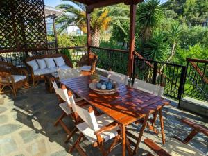 a wooden table and chairs on a patio at Villa Beta - 5min walk to beach, BBQ, Parking in Pefkohori