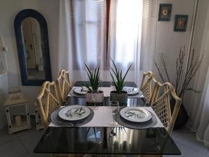 a dining room table with chairs and a mirror at Villa Beta - 5min walk to beach, BBQ, Parking in Pefkohori