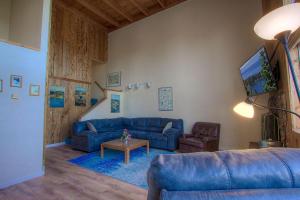 a living room with a blue couch and a table at Life's Better The Milky Way condo in Stateline