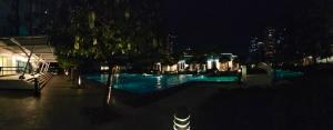 a swimming pool at night with a building at Air Residences Staycation in Manila