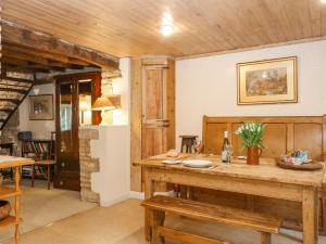 a dining room with a wooden table and chairs at Brooklands in Chedworth