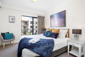 a bedroom with a large bed and a window at 309 Secret City Sanctuary Prkingpoolview in Perth