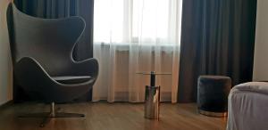 a living room with a chair and a table at Unique Boutique in Bucharest