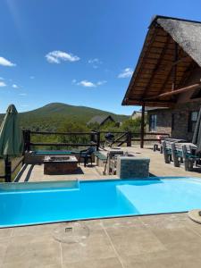 a swimming pool with a view of a mountain at Kubu Khaya Mabalingwe in Mabula