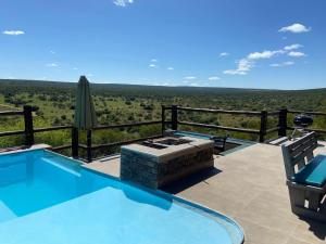 a swimming pool with a view of a field at Kubu Khaya Mabalingwe in Mabula