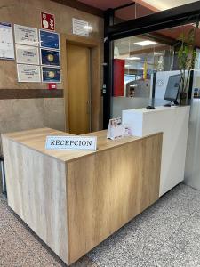 a reception desk in an airport with a sign on it at Andamur San Román in San Román