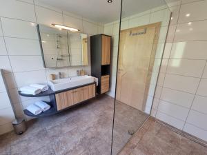 a bathroom with a sink and a shower at Ferienlandhaus Höfer in Fulpmes