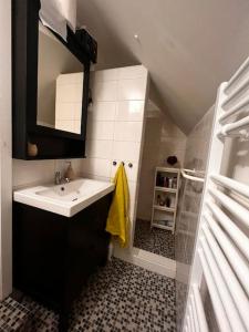 a bathroom with a sink and a mirror at Chatka pod Martinskými Hoľami in Martin