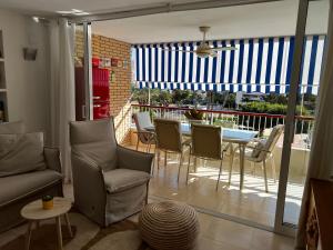 a living room with a table and chairs at BEACH & URBAN PLAYA SAN JUAN in Alicante