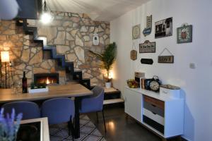 a room with a staircase and a stone wall at Robinson crusoe style house "MASLINA'' in Škrip