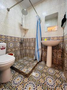 a bathroom with a toilet and a sink at AL-MOTRUDIY in Samarkand
