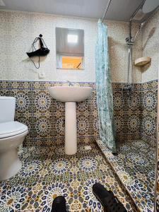 a bathroom with a sink and a toilet at AL-MOTRUDIY in Samarkand