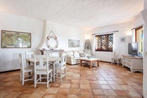 a living room with a table and a couch at Villa Regina Margherita in Olbia