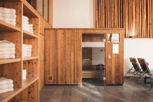 a room with wooden walls and a door to a room with towels at ALFA hotel in Serfaus +79 photos