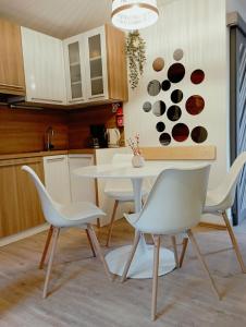 a kitchen with a white table and chairs at ABC apartments in Kamnik